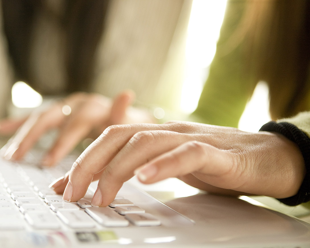Marketplace &ndash; A woman in a green sweater types on a keyboard
